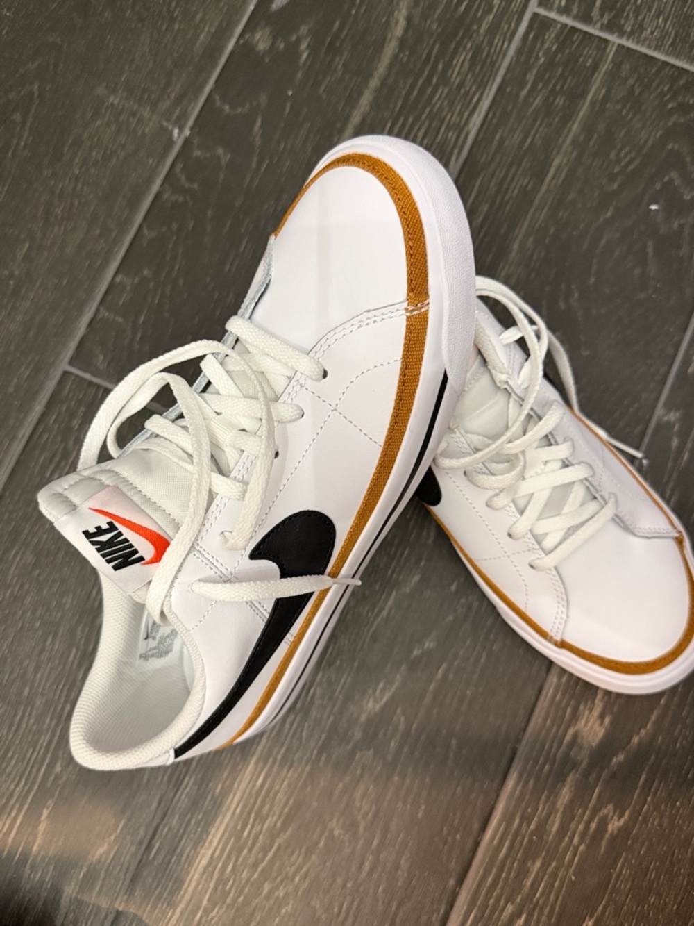 Nike White Leather Low-Top Sneakers with Black Swoosh and Mustard Accent